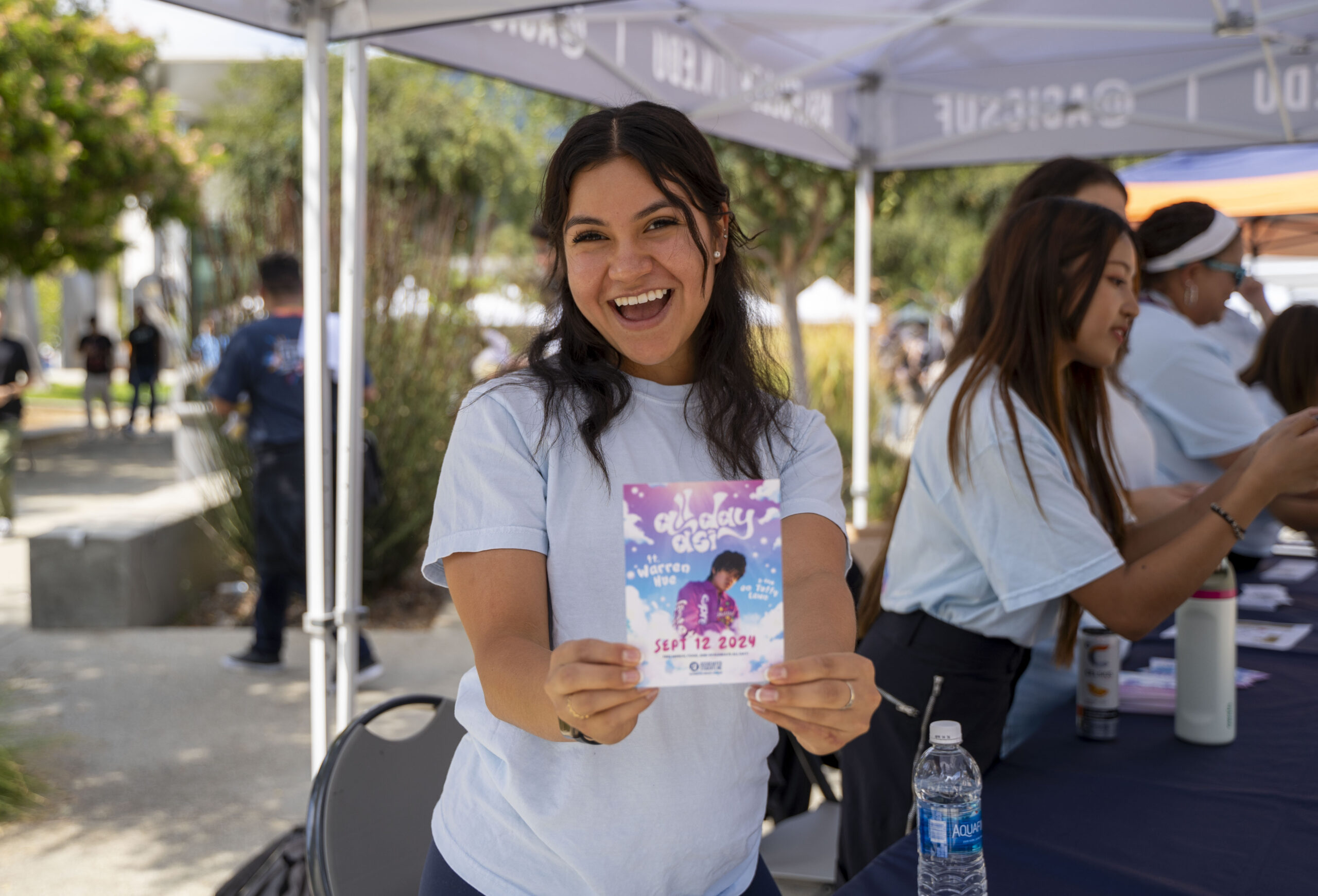 ASI vice president Suzy Morales poses with an All-Day ASI flyer