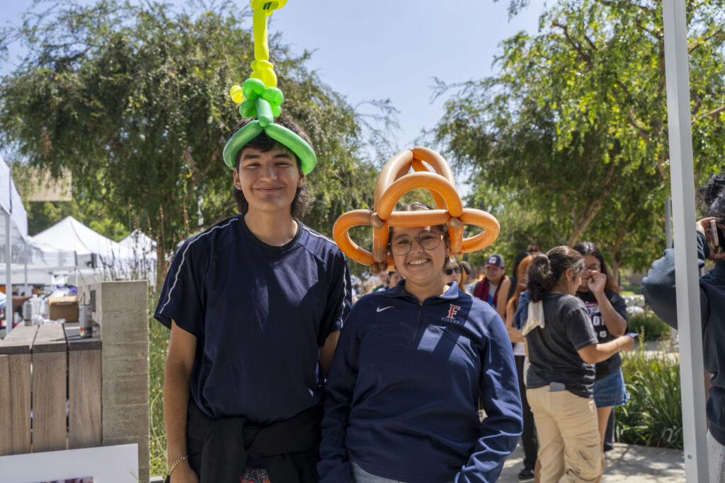 CSUF students pose with their balloon hats made at All-Day ASI 