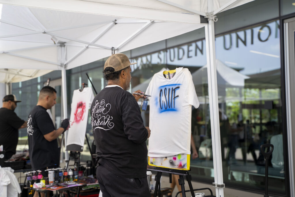 Graffitied CSUF t-shirts are made by an artist.