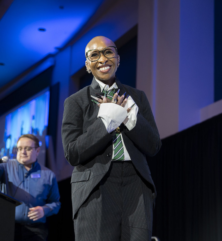 Erivo walking onto stage at ASI's Beyond the Conversation event. 