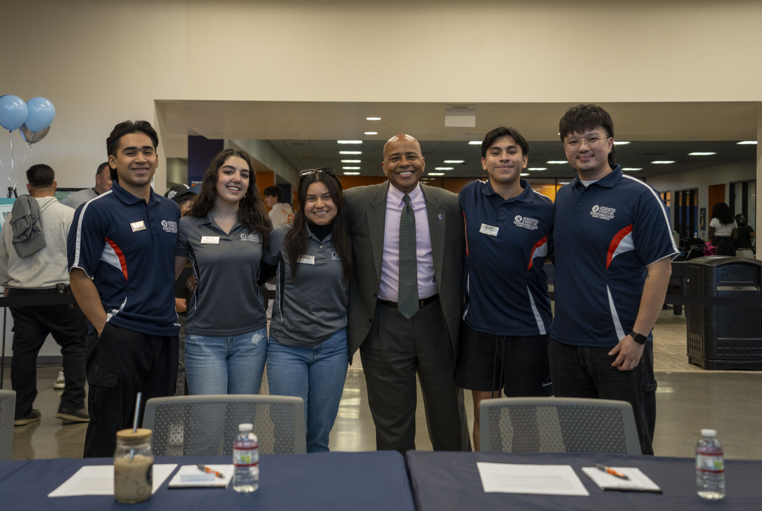 ASI Student leaders and President Rochon pose for a photo