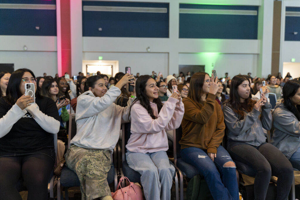 Students in the audience record the Suburb Talk members.