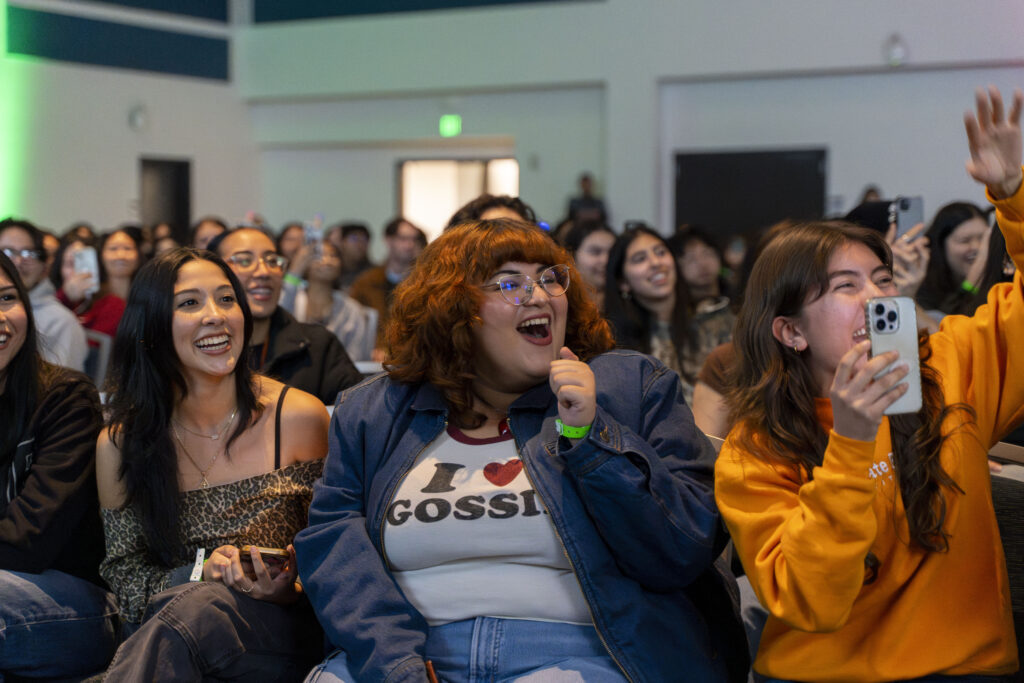 Audience members smile and laugh at Titan Talks