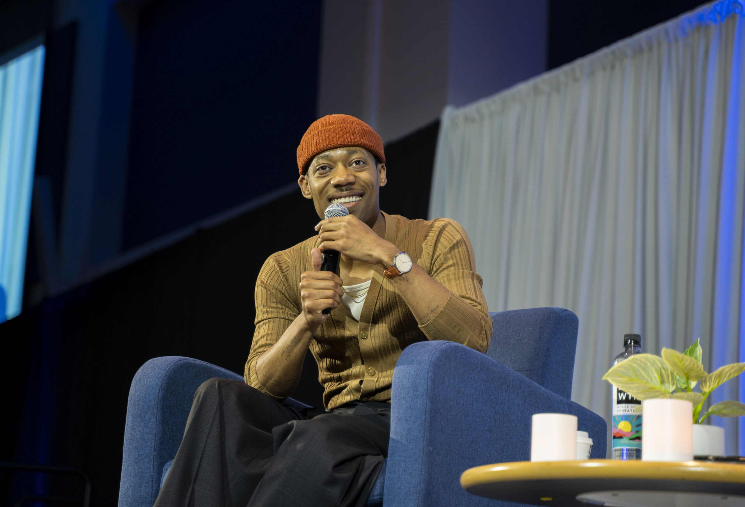 Tyler James Williams smiling while interviewing at Beyond the Conversation.