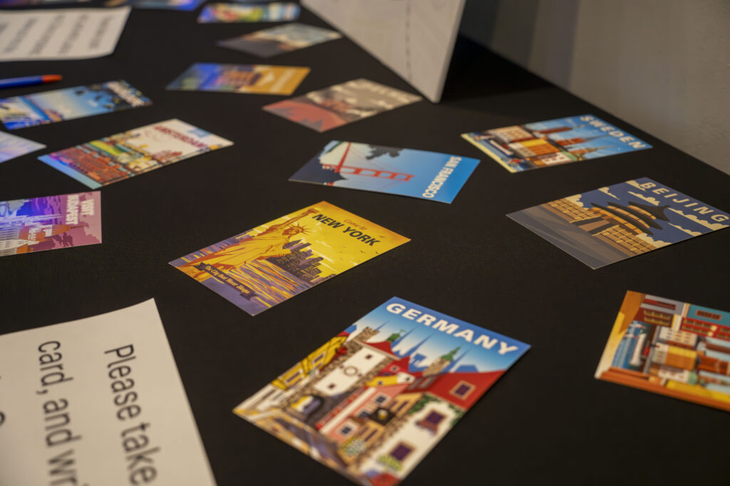 Postcards from various countries on a black countertop