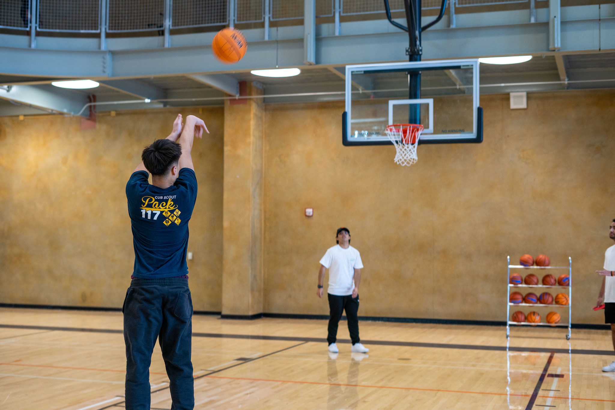 Person shooting a basketball.