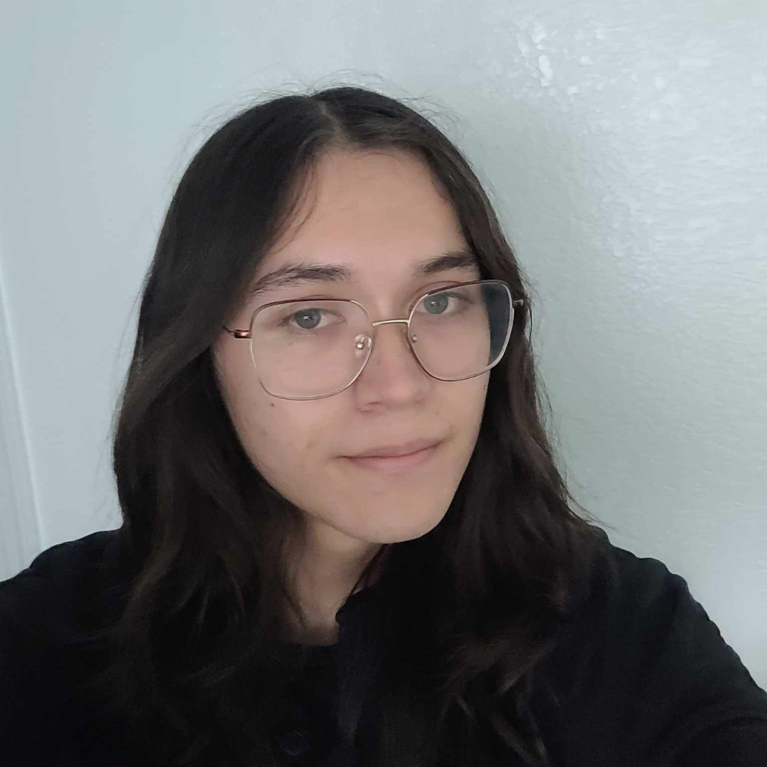 a young man with long hair and glasses