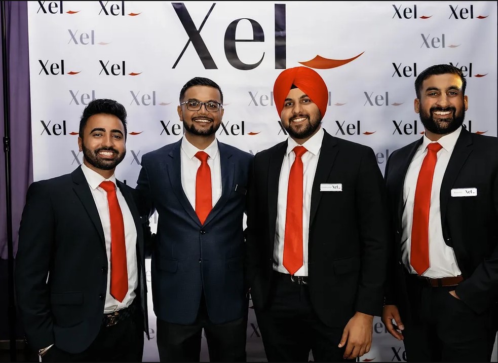 Four men dressed in suits standing together