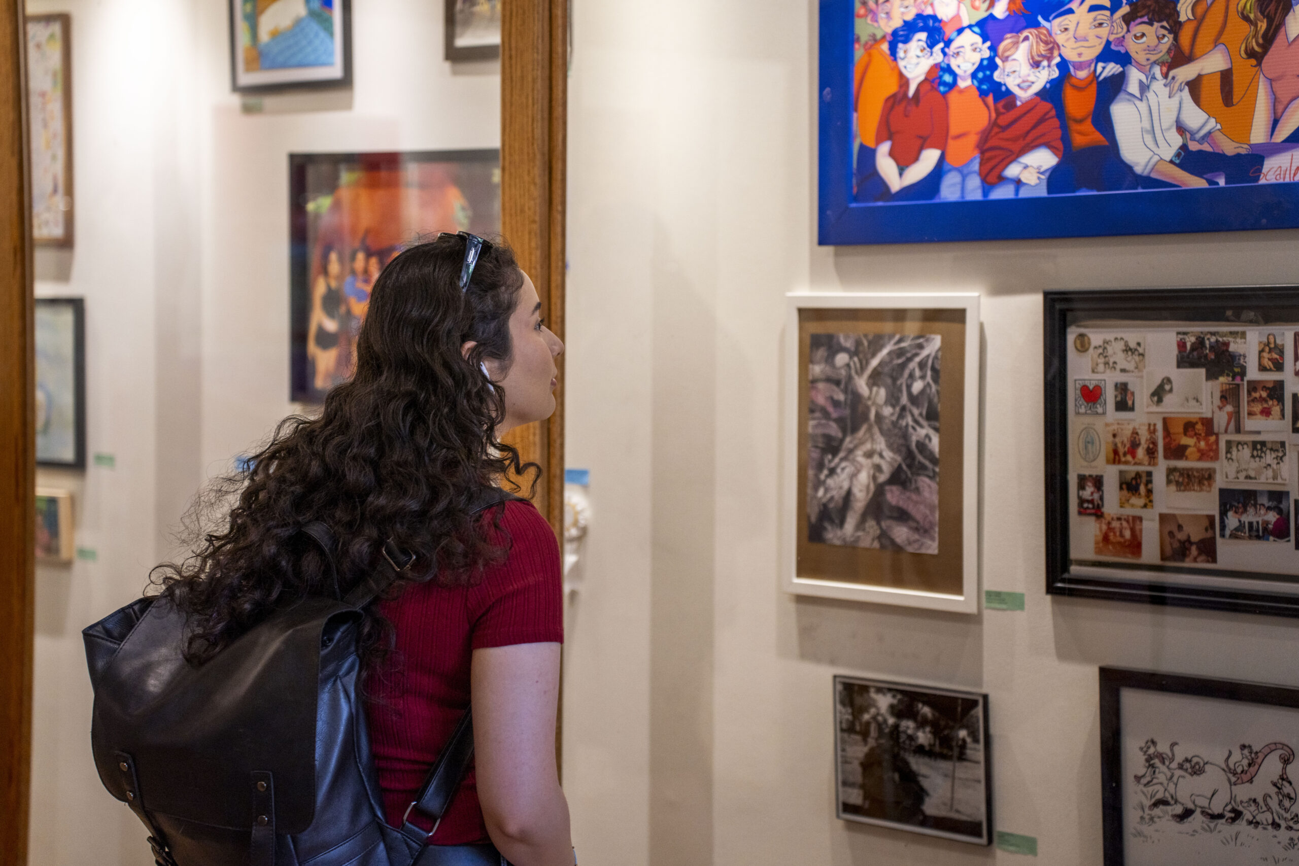 girl looking at art on wall