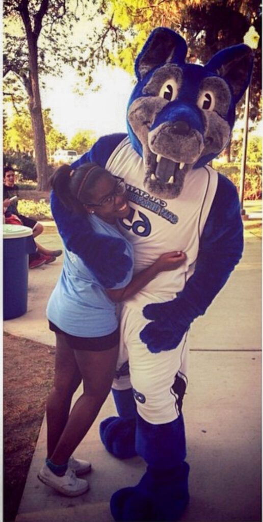 a girl hugging a college mascot 