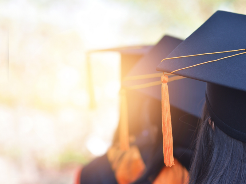 a group of graduates with grad cap standing in a line