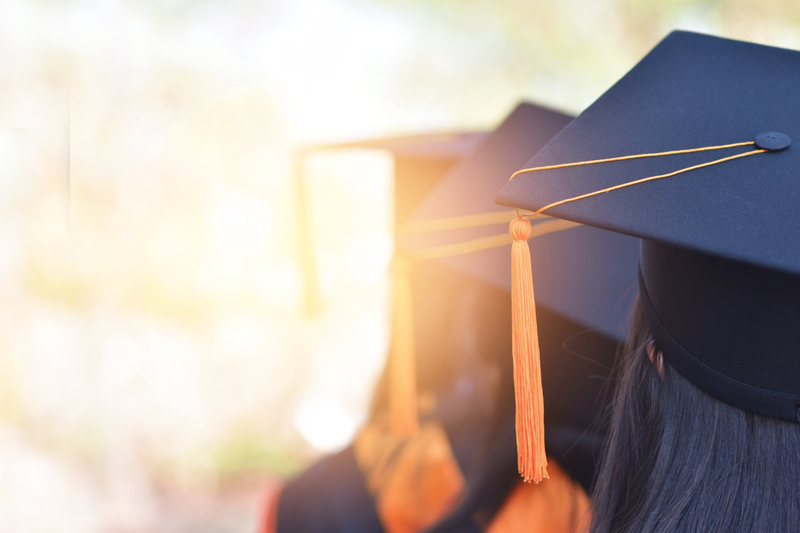 a group of graduates with grad cap standing in a line