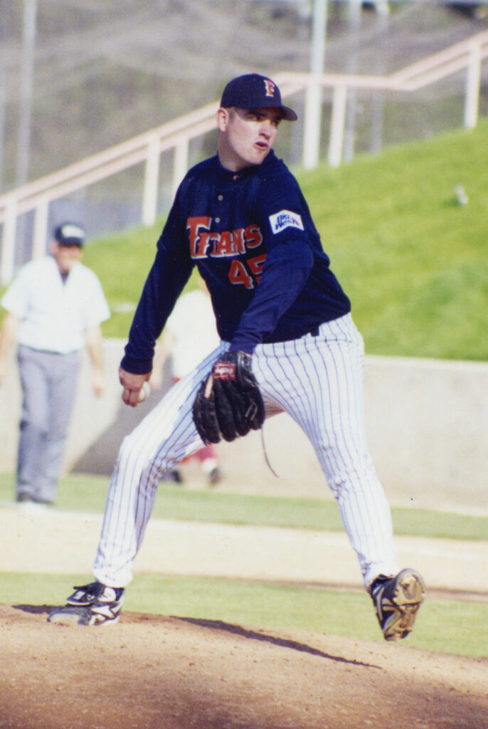 a young man on a pitching mound pitching