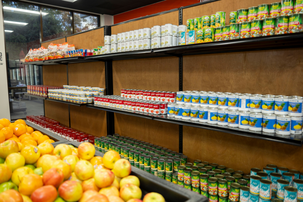 oranges and canned food in a pantry shelf