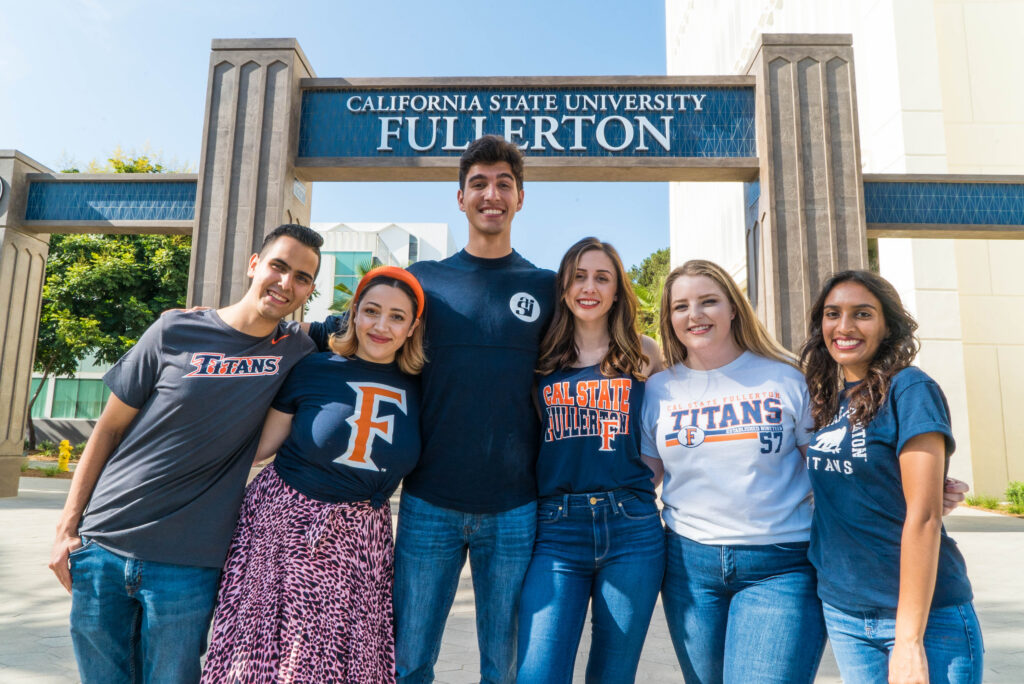 group of students in front of a cal state Fullerton sign