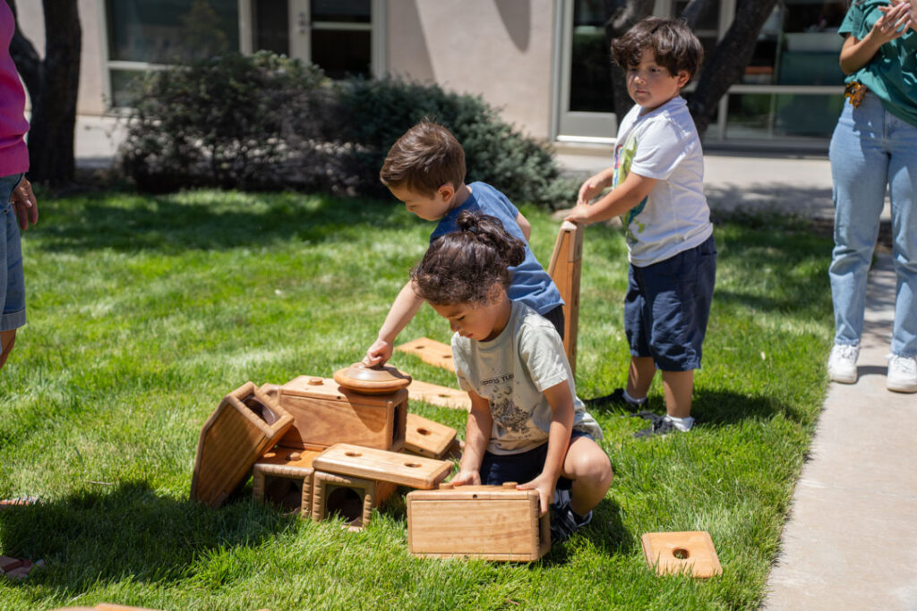 children playing on the grass with building blocks