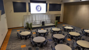 Portola Pavilion all with round tables and screen