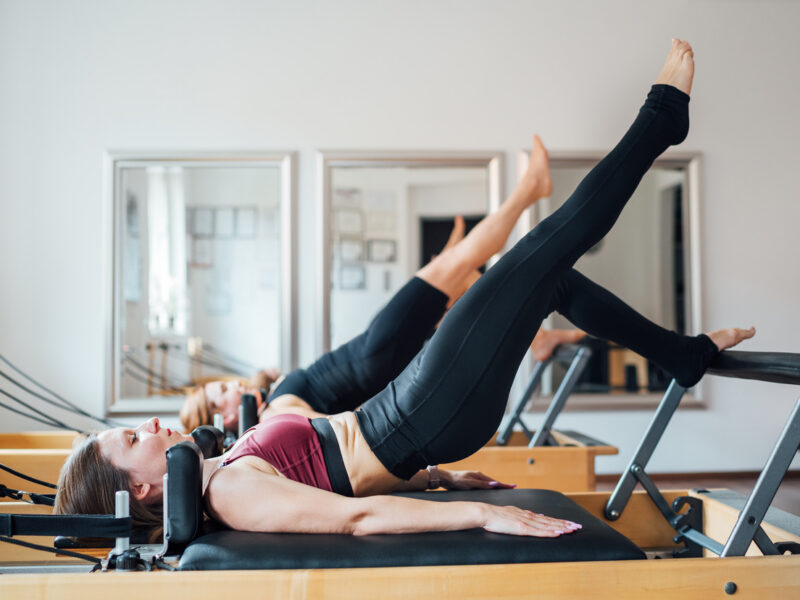 women on a reformers pilates machine