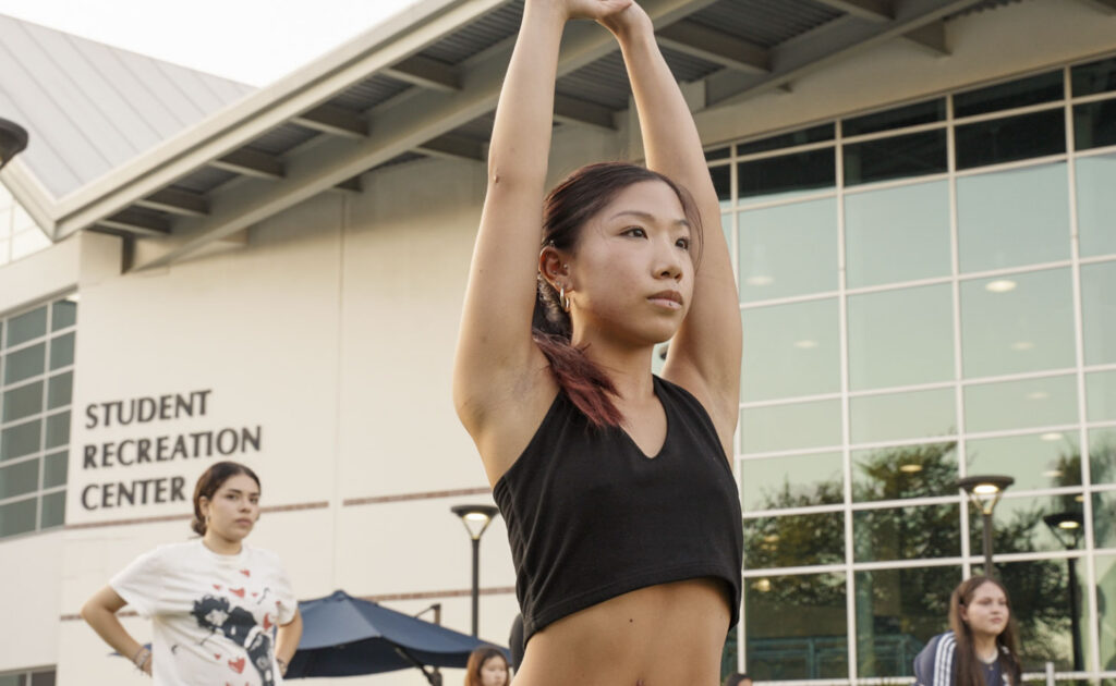 a girl stretches her arms in front of the camera