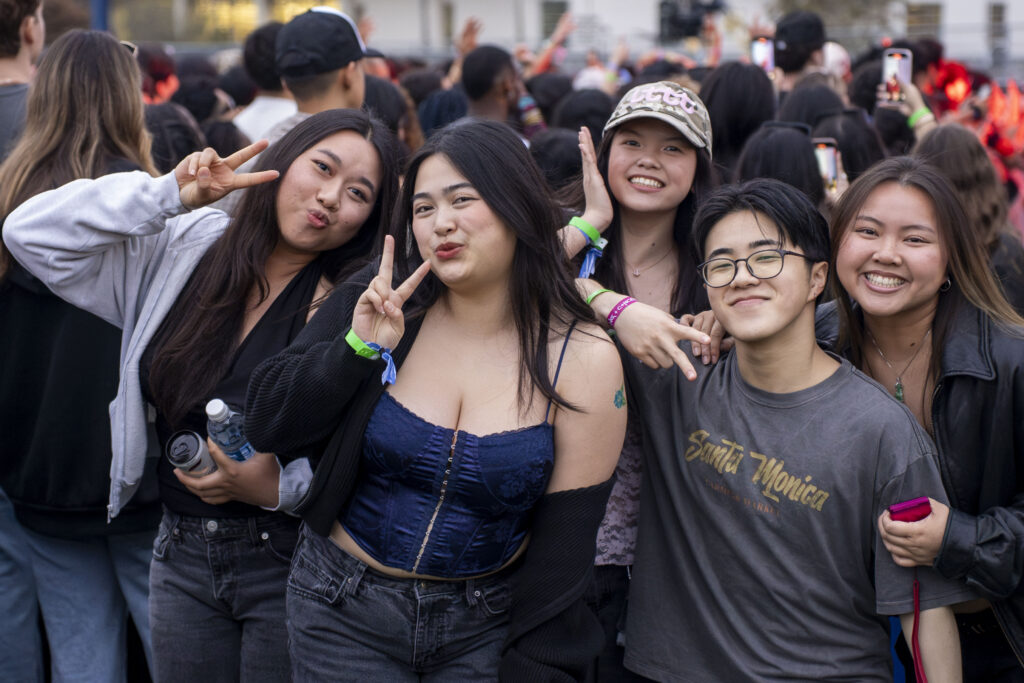 a group of college students pose for a picture at a concert 