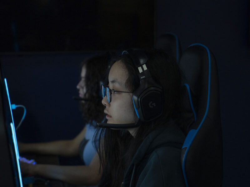 two girls gaming in front of computers