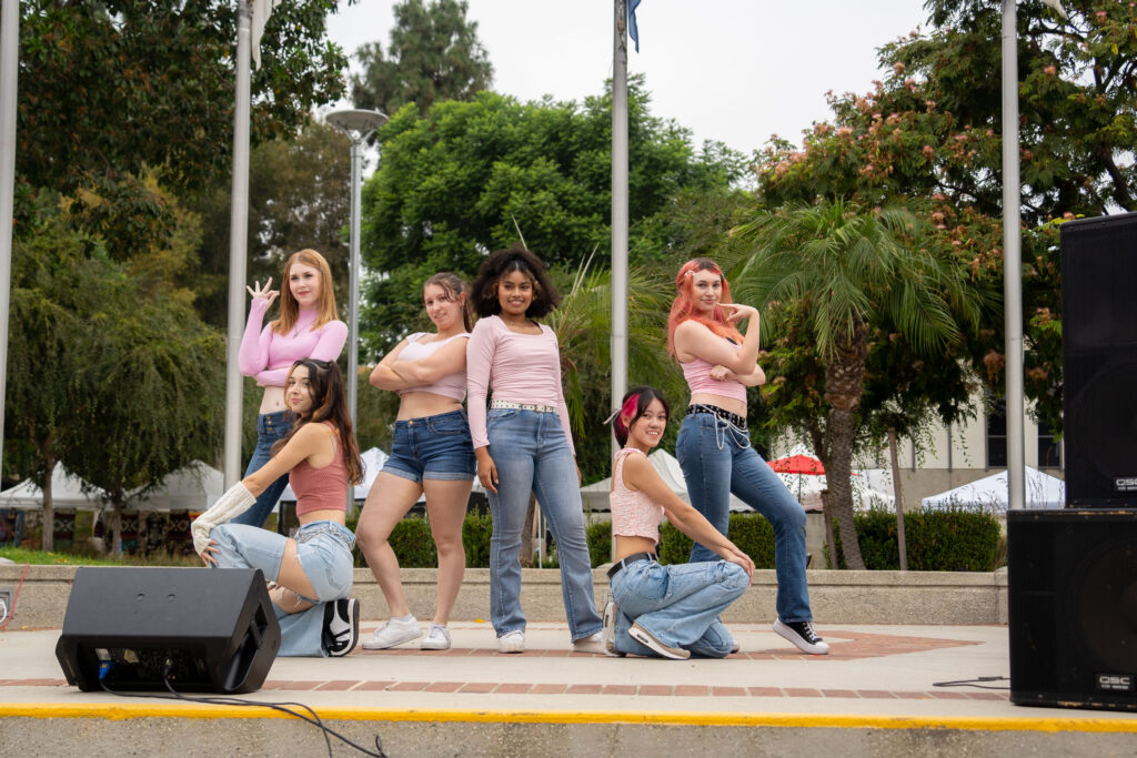 a group of kpop dancers dressed in pink