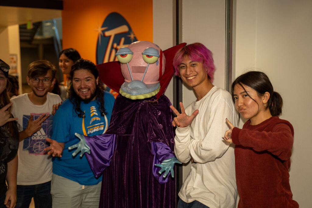 a group of students dressed up in costume posing for a picture together 