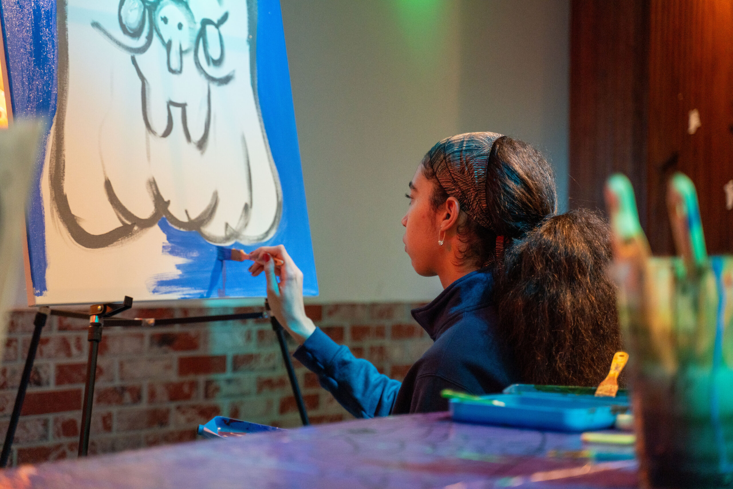 Girl painting on a canvas