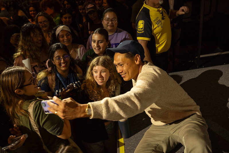 Jon M. Chu posing for a selfie with CSUF students 