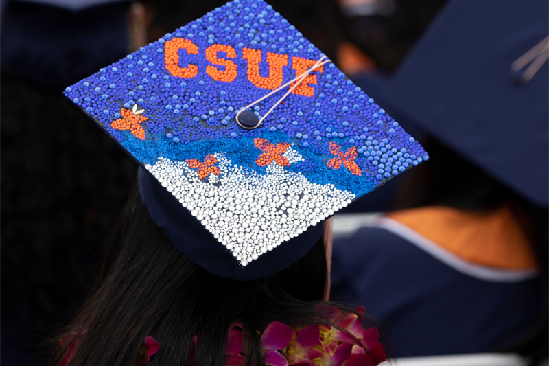 decorated graduation cap at CSUF commencement