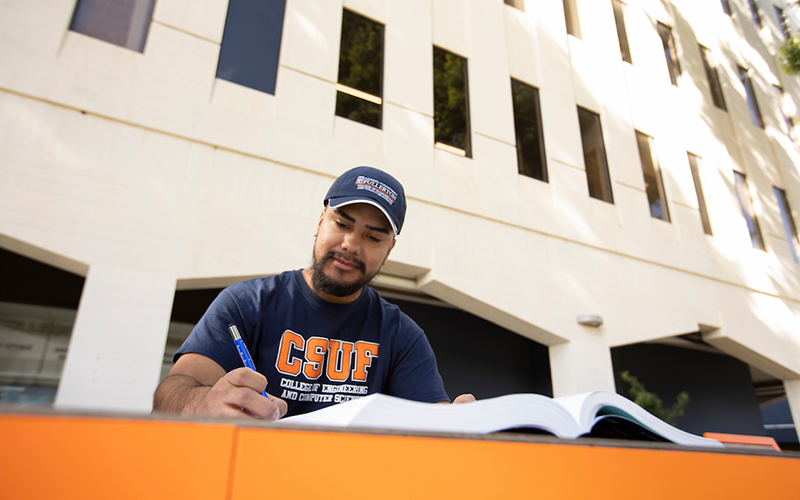 student outside library studying