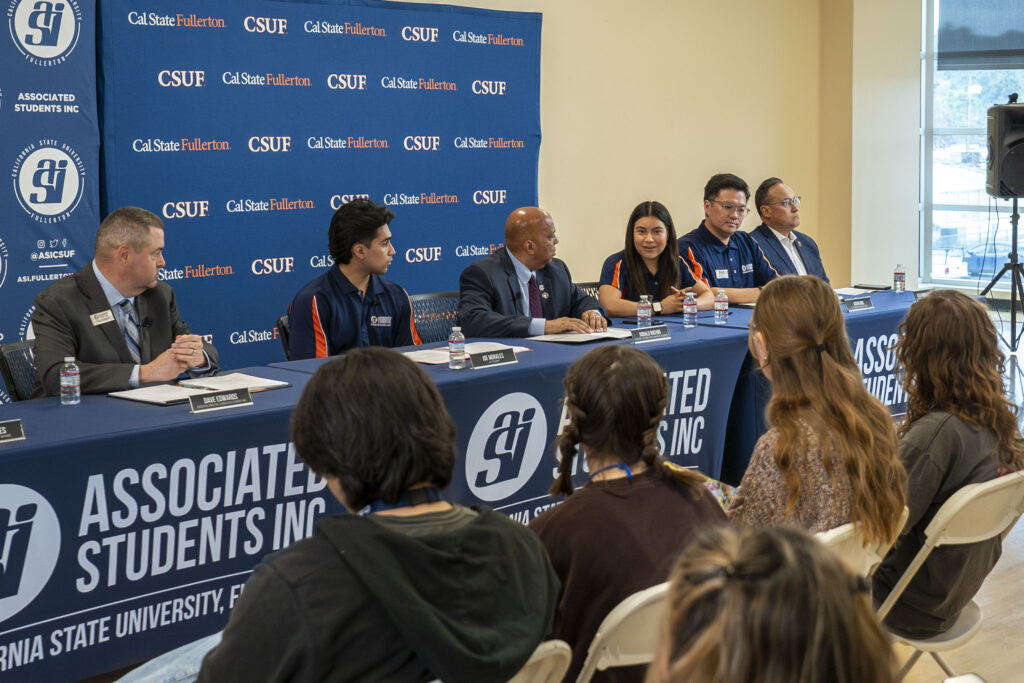 collebge students and campus leadership sitting at a press conference 