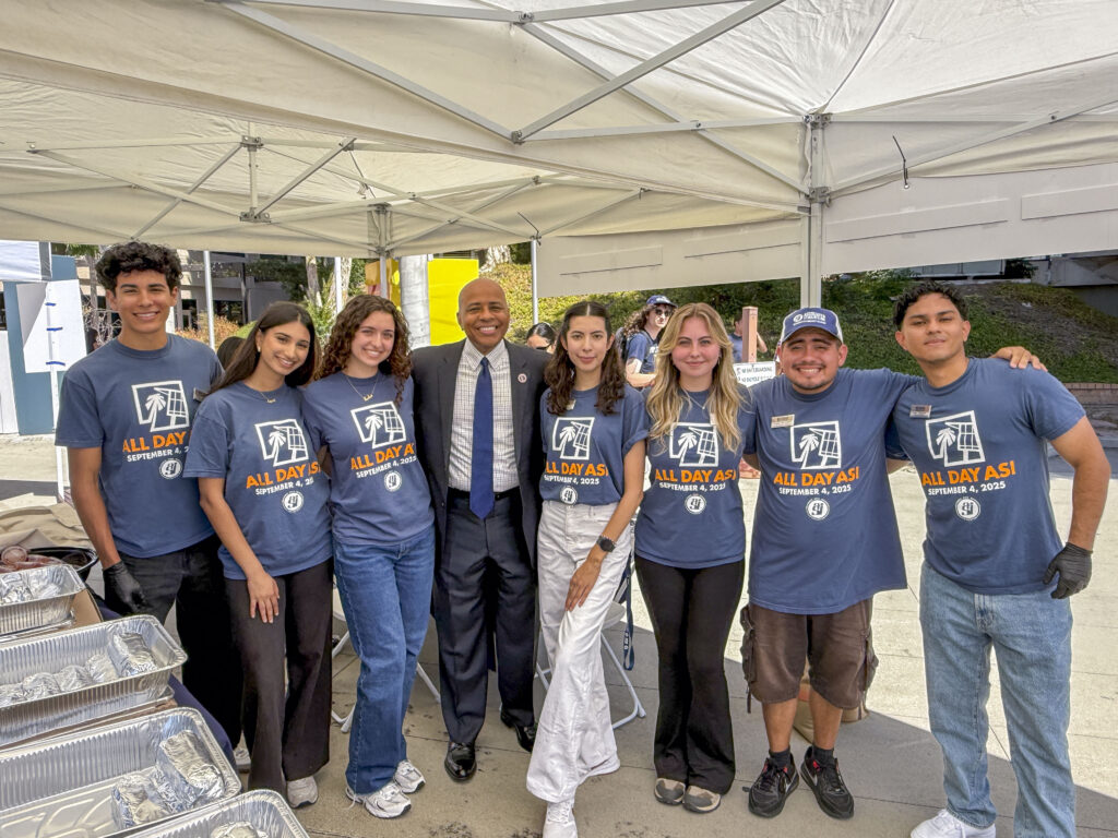 a group of students posing with a man in a suit