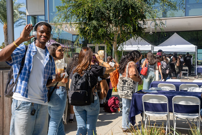 54774366681_9fc992e2d6_c Student in line waving at All Day ASI