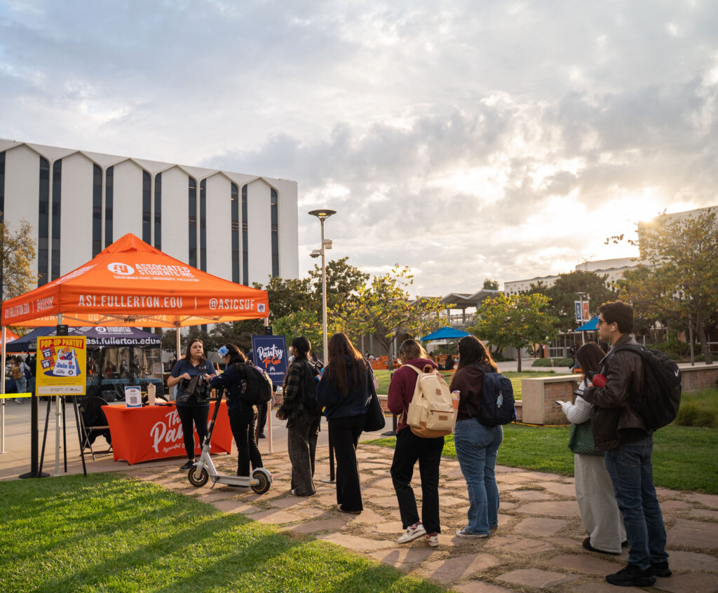 a line of students in line at a food pantry
