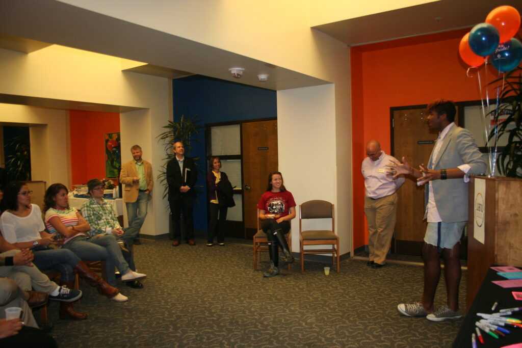 A man gives a speech to a room of people