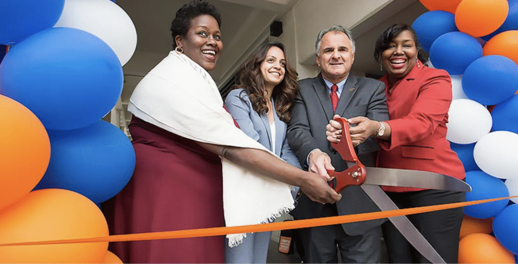 a group of campus leaders ribbon cutting the opening of basic needs center