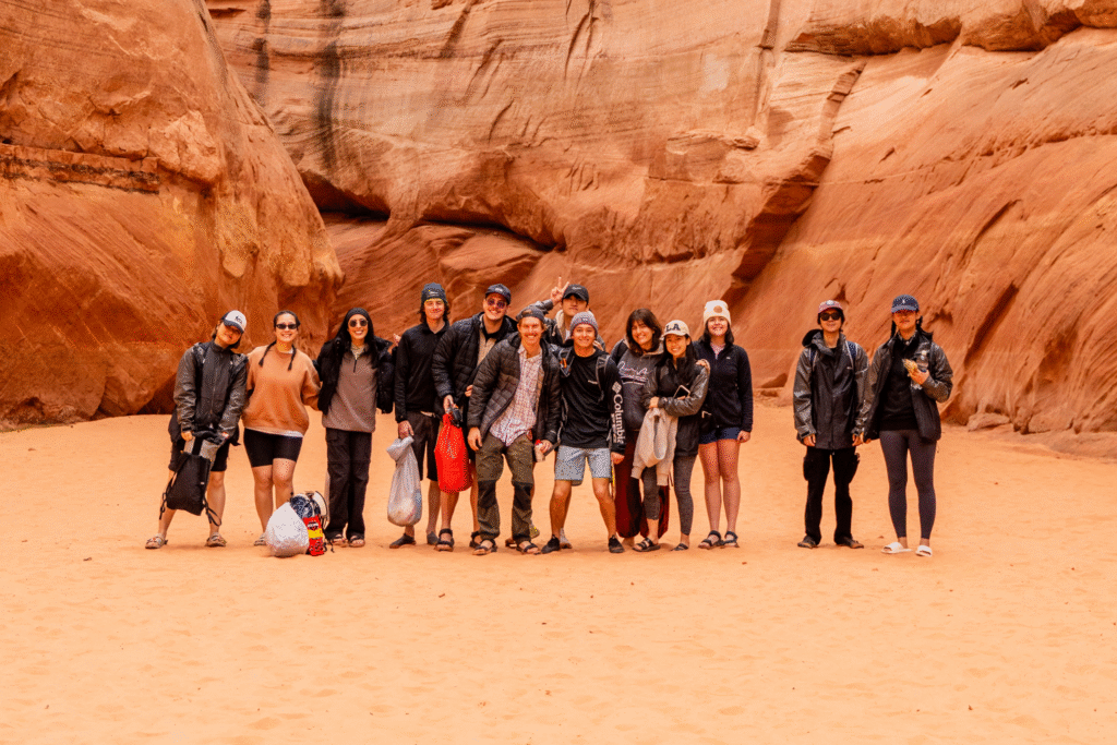 a group of college students pose for a picture at the grand canyon