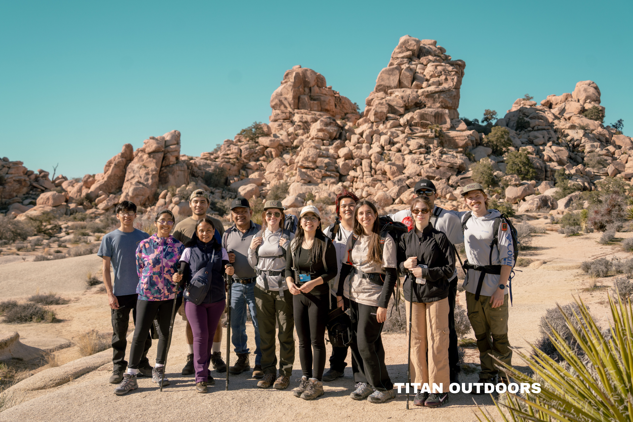 a group of college students posing in front of a mountain