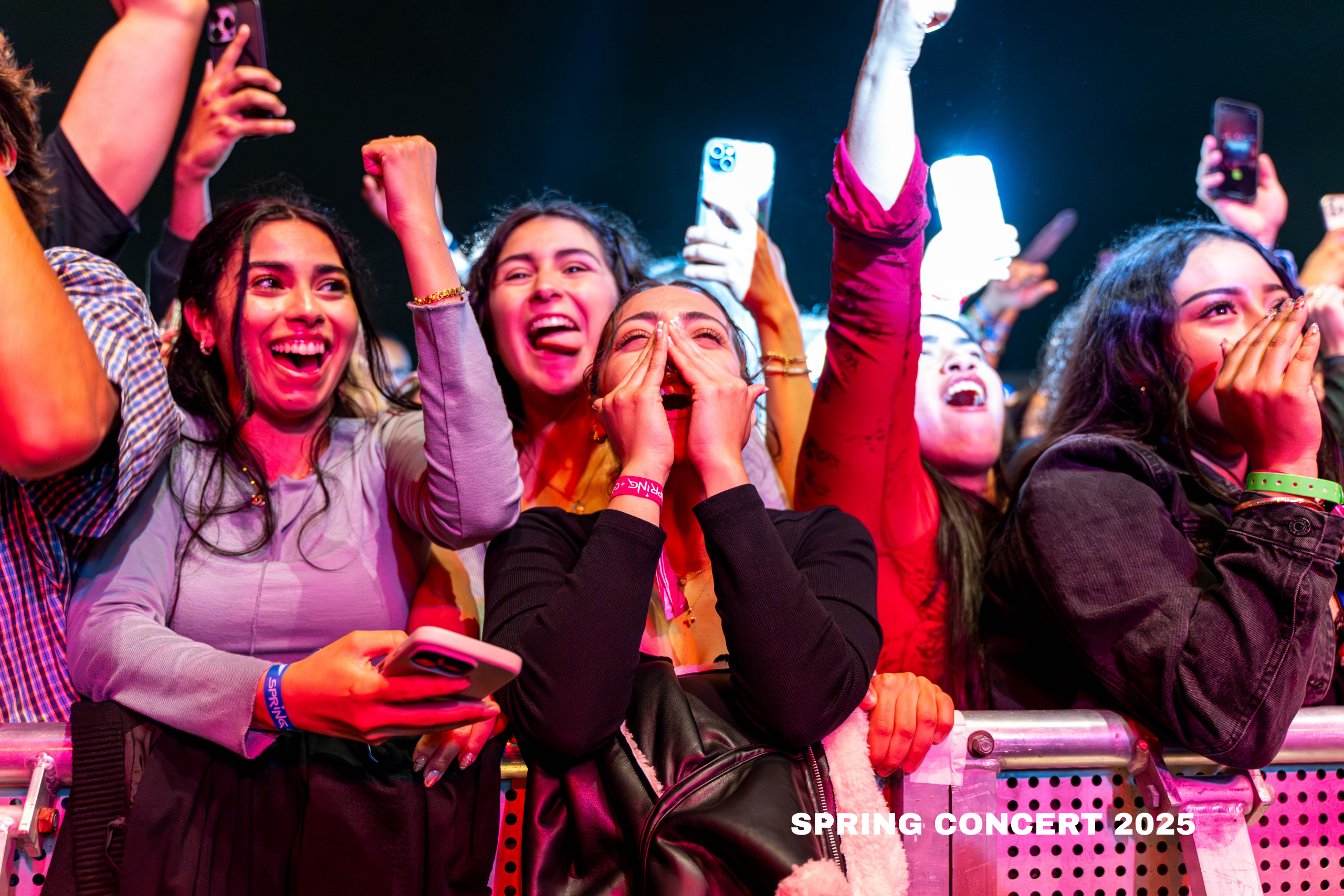 young women scream at a concert