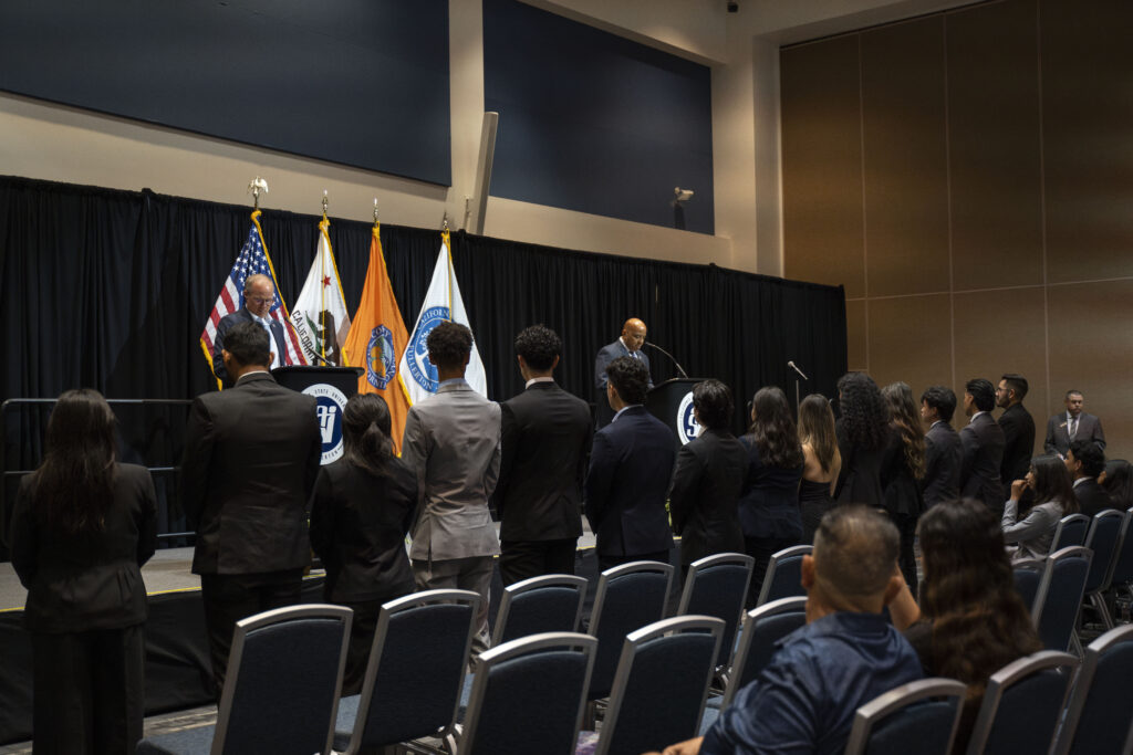 a group of students in suits standing in a line
