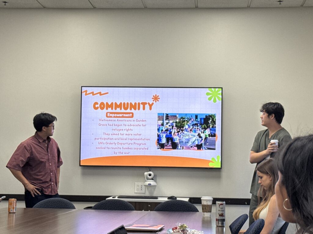 two young men stand anf give a presentation