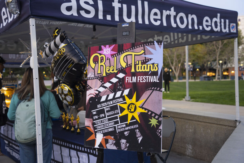 A sign that says "Reel Titans" in front of a canopy