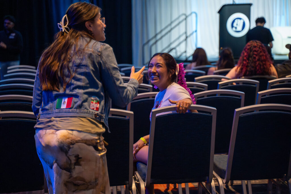 two women smile and talk together