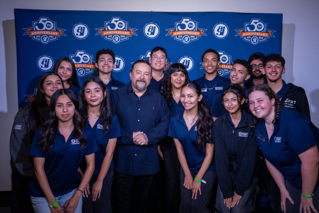 Mr.Cartoon poses alongside college students