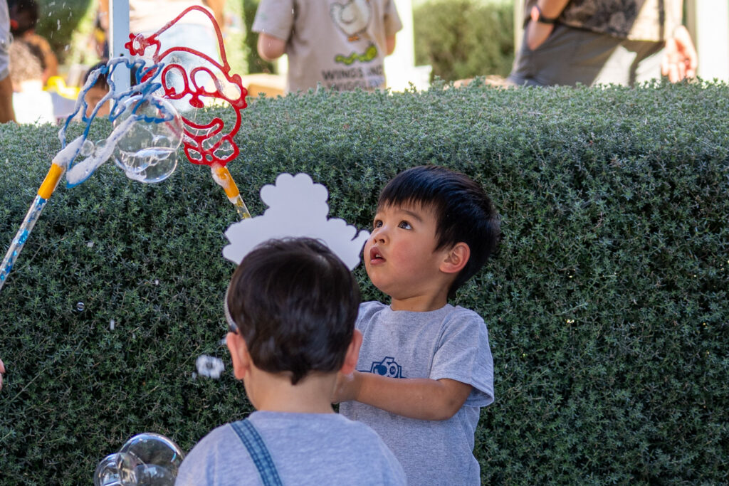 a child holding a bubble wand