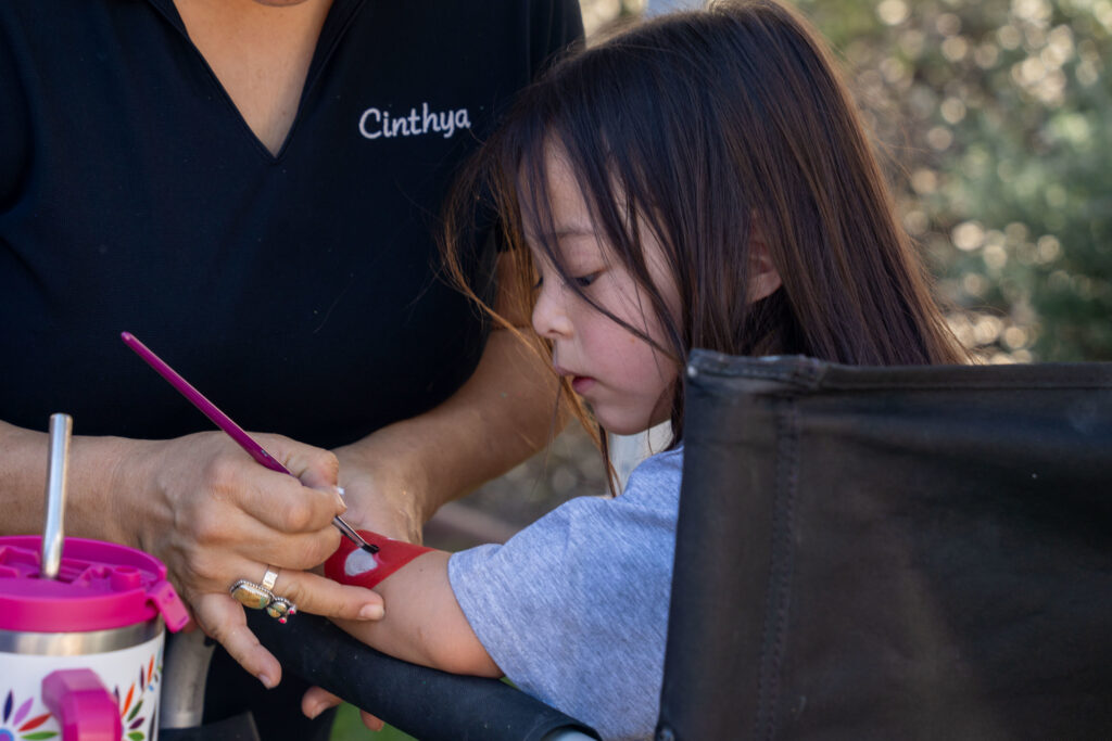 girl getting her arm painted