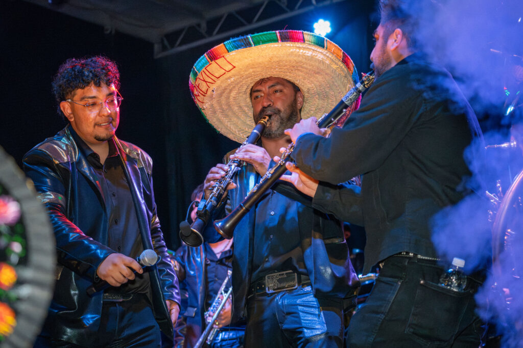 a group of men in sombreros play instruments 