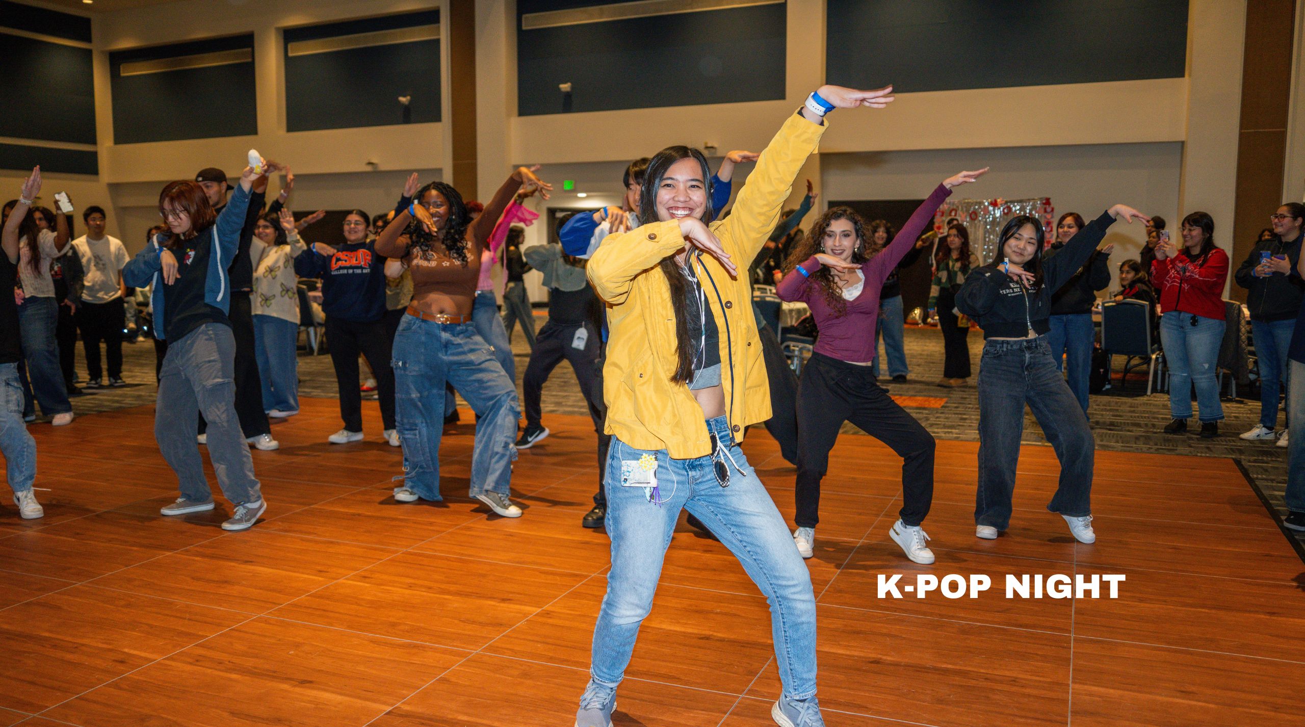 a girl in yellow dances to kpop music