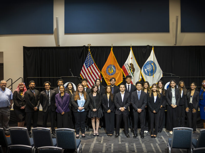 a group of young men an d women in suits